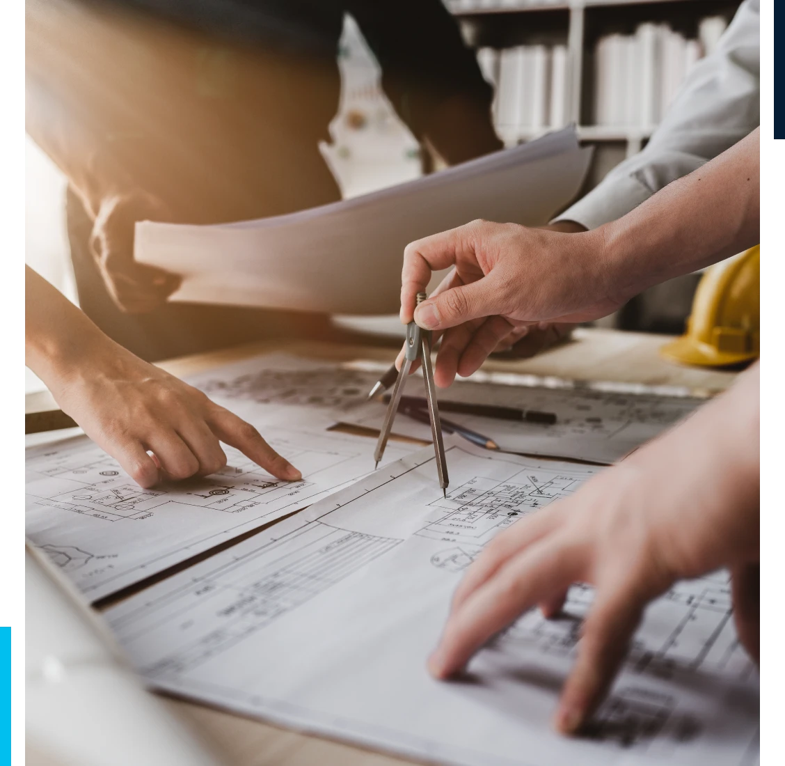 Architects reviewing blueprints with compass